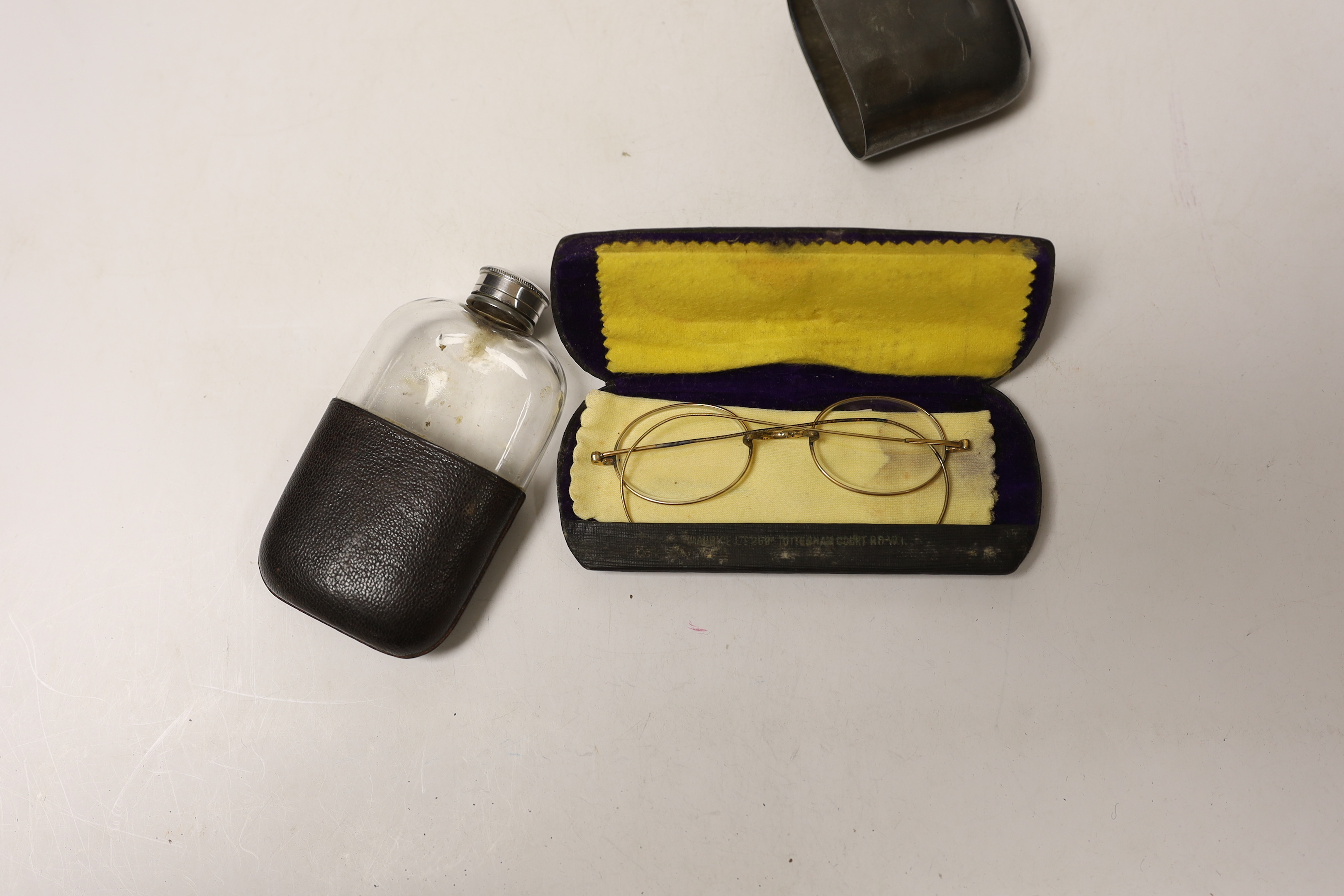 Assorted spectacles in cases, scent bottle and flask.